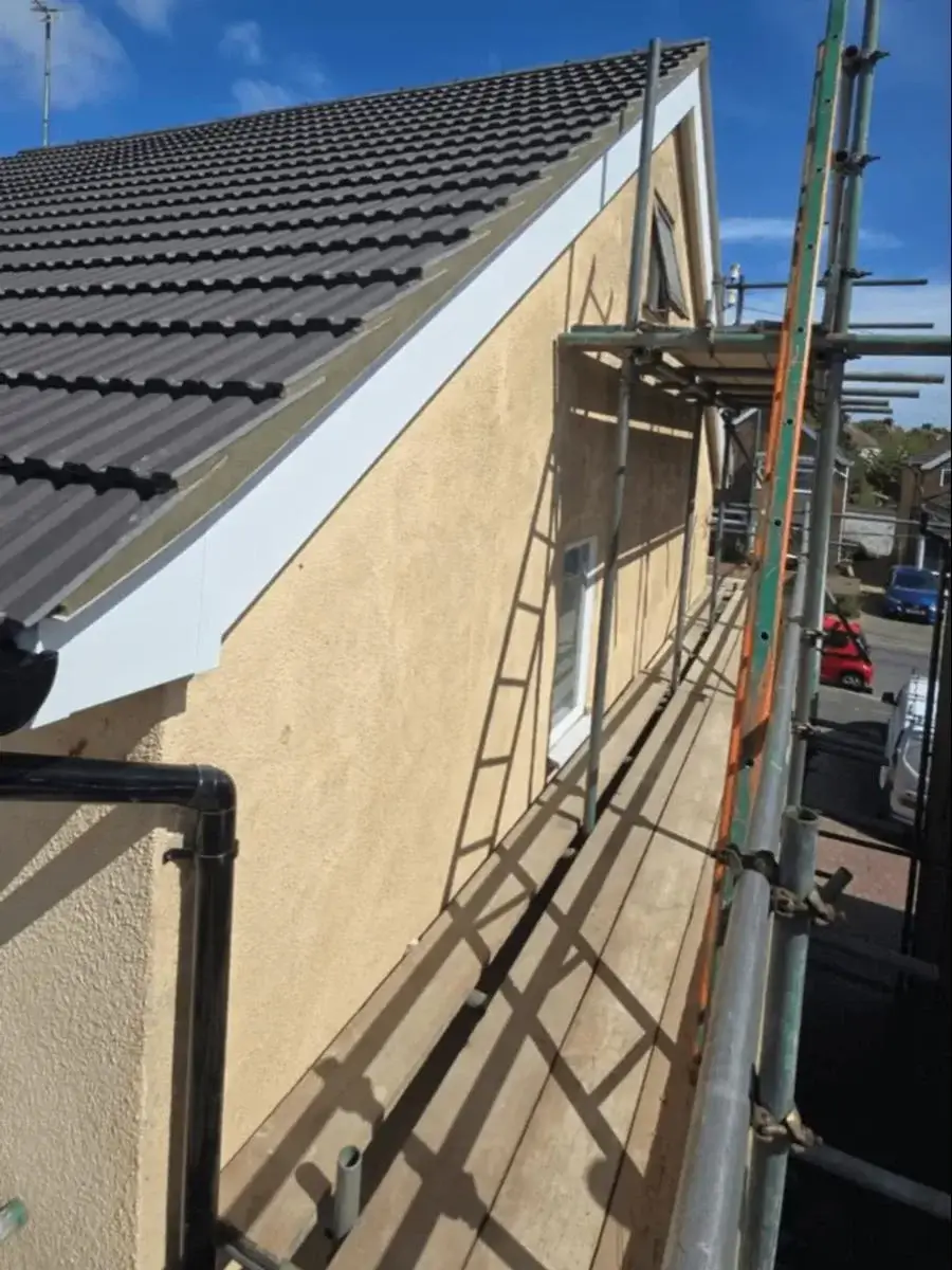 Clean white uPVC fascia boards and crisp edge trim detailing on a newly tiled roof gable end. Completed by Norfolk Exterior Solutions